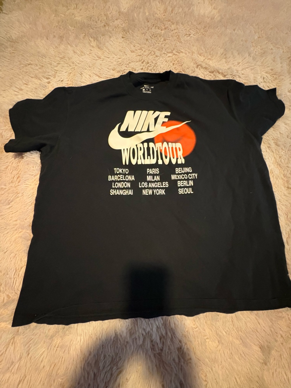 Nike Black Tee with White Logo and Orange Accent